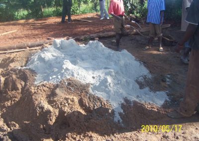 The whitish is the cement poured on the sand and hardcore for mixing, prepared for the slab 4